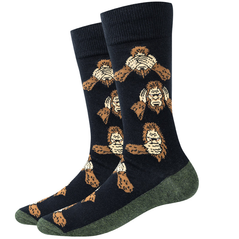 Unisex Bigfoot see no evil crew socks in black with three Bigfoots covering eyes, ears and mouth, product shot of a pair