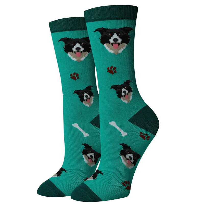 Women's Border Collie crew socks flat lay, green with black and white collie faces and paw prints
