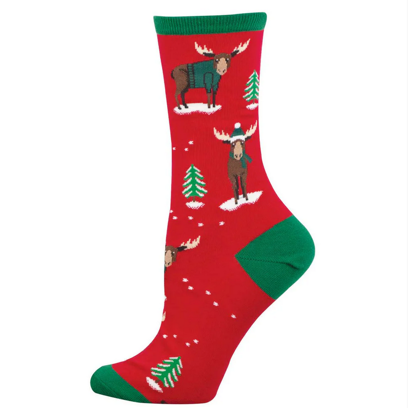 Women's Christmoose crew socks laid flat, red with sweater-wearing moose and evergreen trees on a snowy background