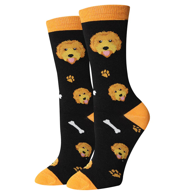 Women's Goldendoodle crew socks flat lay, black with curly golden doodle faces and paw prints