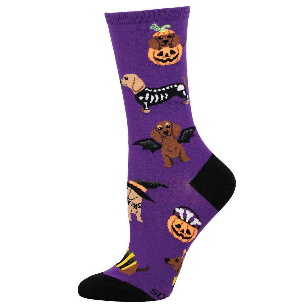 Women's Halloween dachshund crew socks in purple with costumed wiener dogs, worn on foot