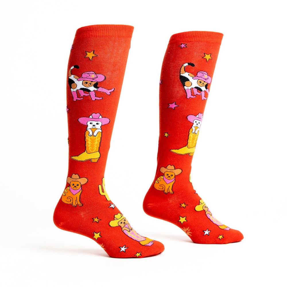 Women's cowboy cat high socks, flat pair side view showing cowboy cats on red
