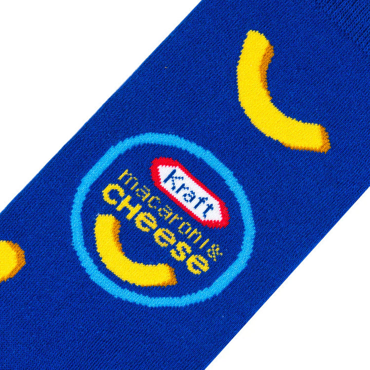 Close-up of the Kraft Macaroni &amp; Cheese logo and noodle pieces on royal-blue sock fabric