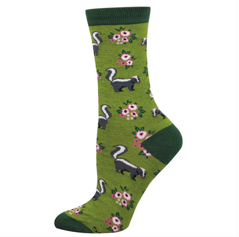 Women's love you stinky crew socks laid flat, green with black-and-white skunks and pink flowers