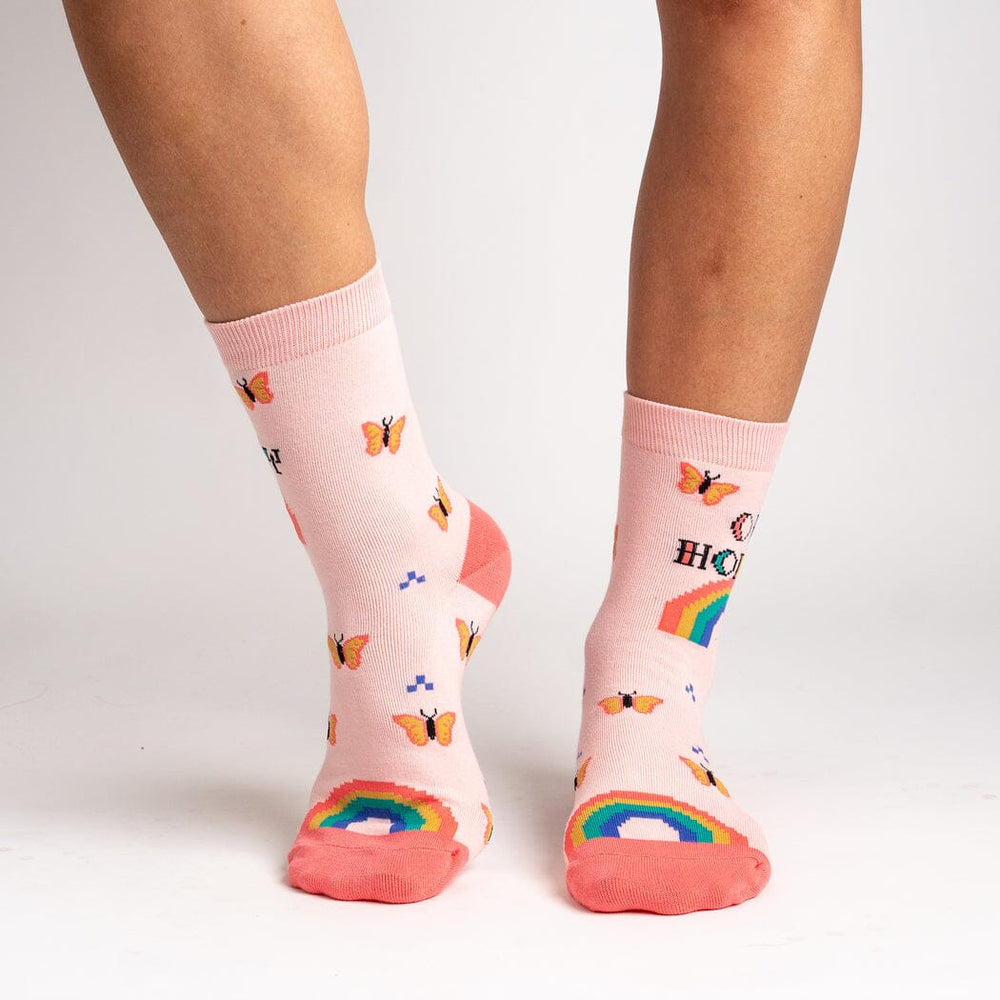 Women's Oh Honey crew socks, worn front view, rainbows and butterflies on pink