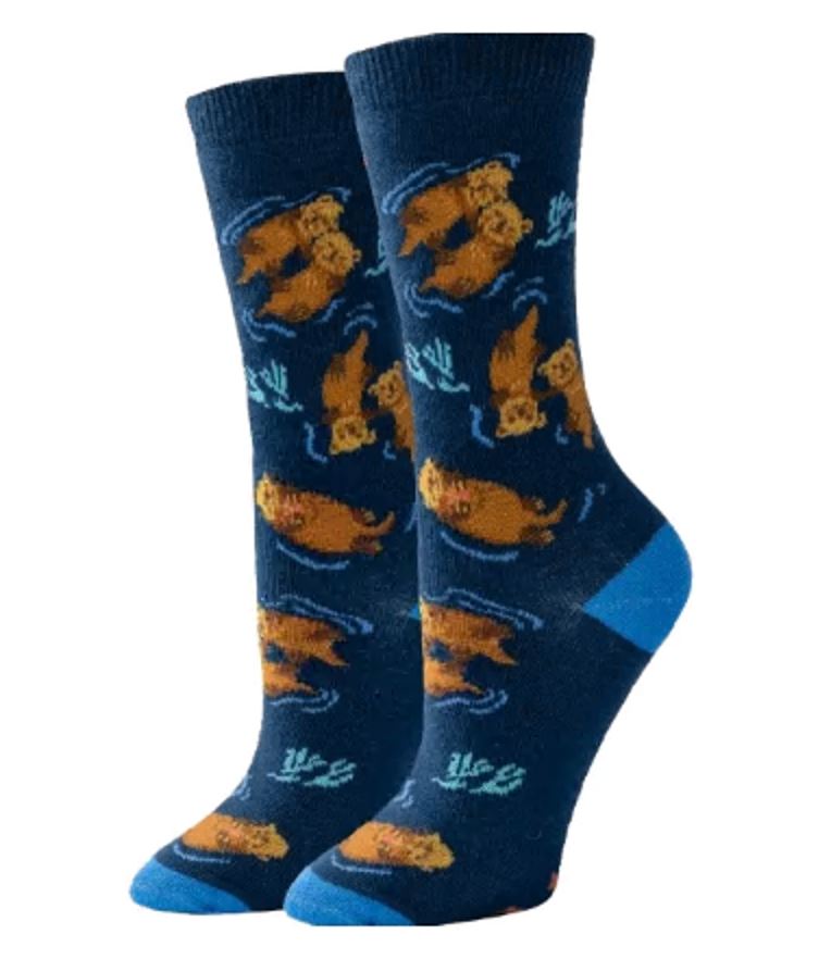 Women's otter crew socks flat lay, navy with brown sea otters, waves, and teal kelp