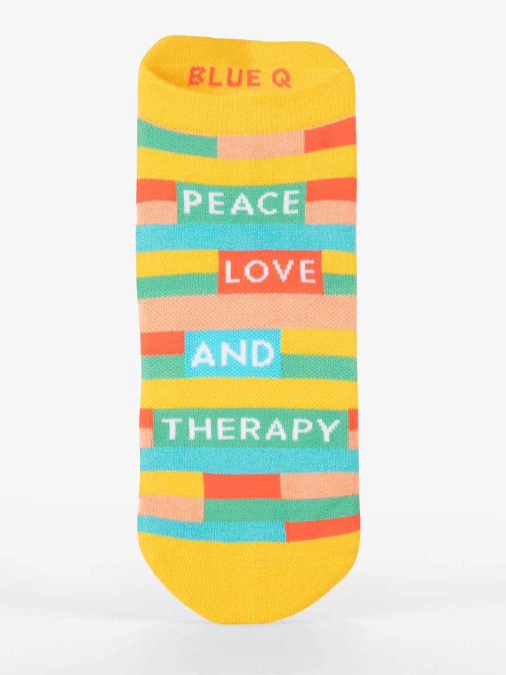 Women's peace love and therapy sneaker socks flat lay, yellow with colorful stripes and text