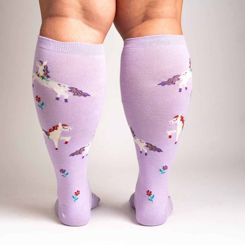 Women's lavender unicorn knee high socks worn, back view showing extra-stretch calf