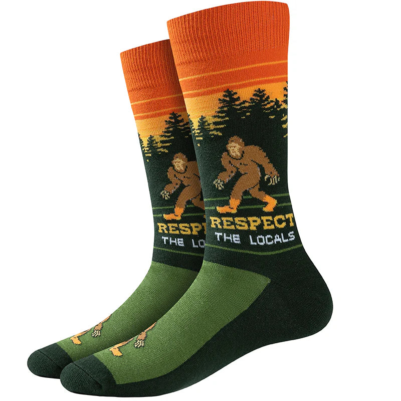 Unisex Bigfoot crew socks with forest sunset scene, flat lay