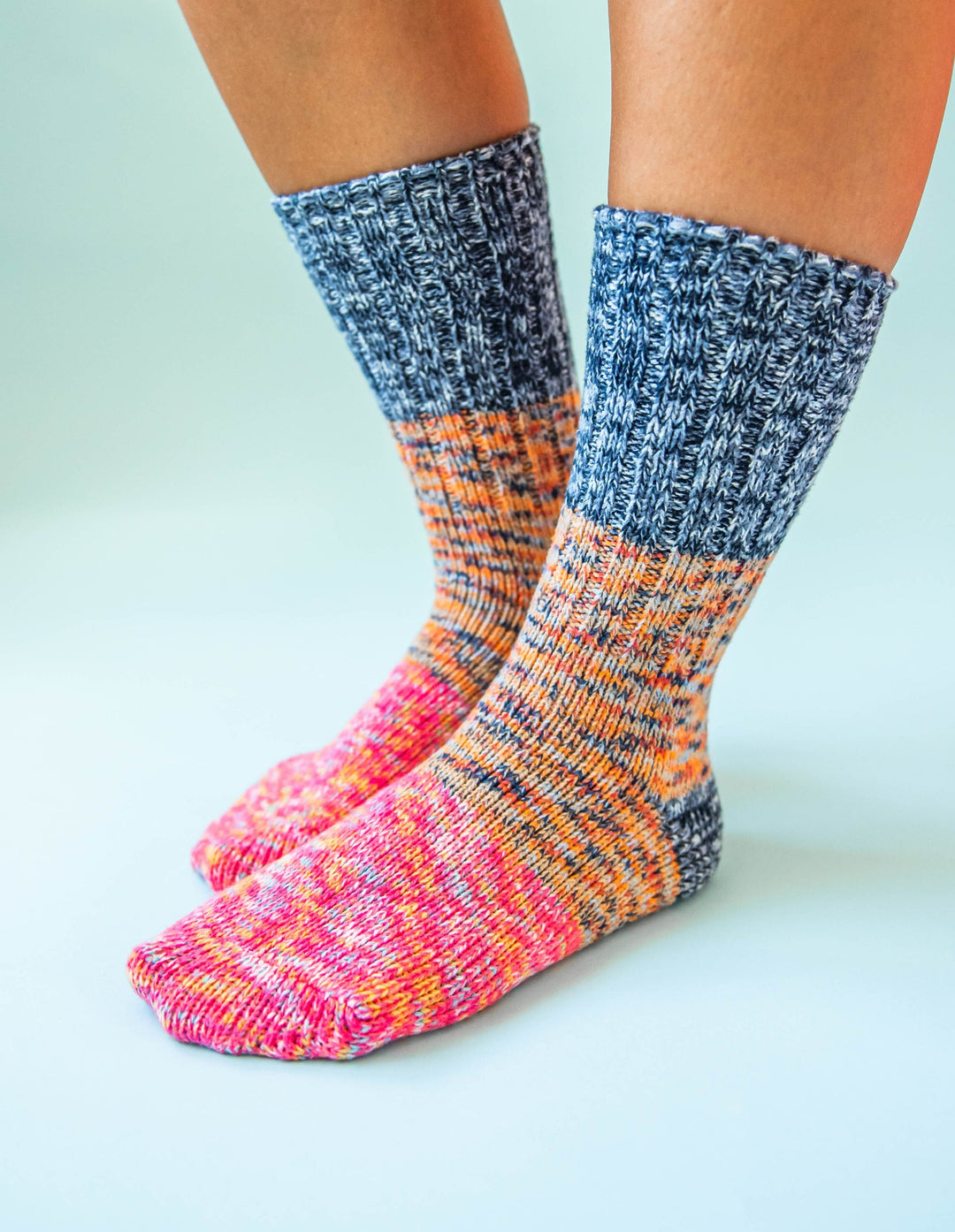 Women's marled ragg crew socks worn, gradient from gray-blue to orange and pink