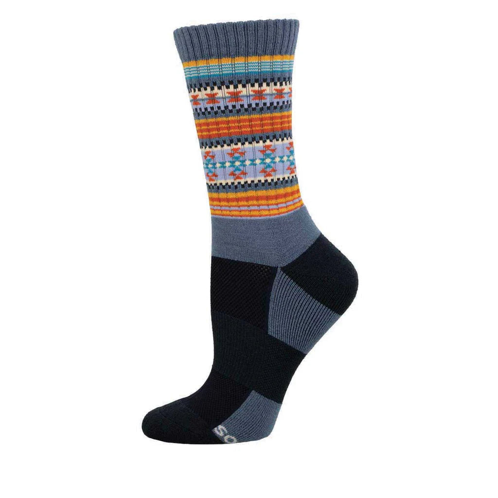 Women's serape crew socks in denim blue with colorful striped pattern, worn on foot