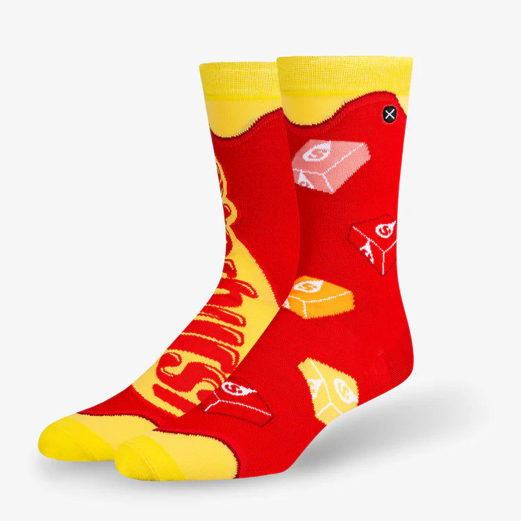 Men's Starburst crew socks angled flat lay with candy squares and logo on red and yellow