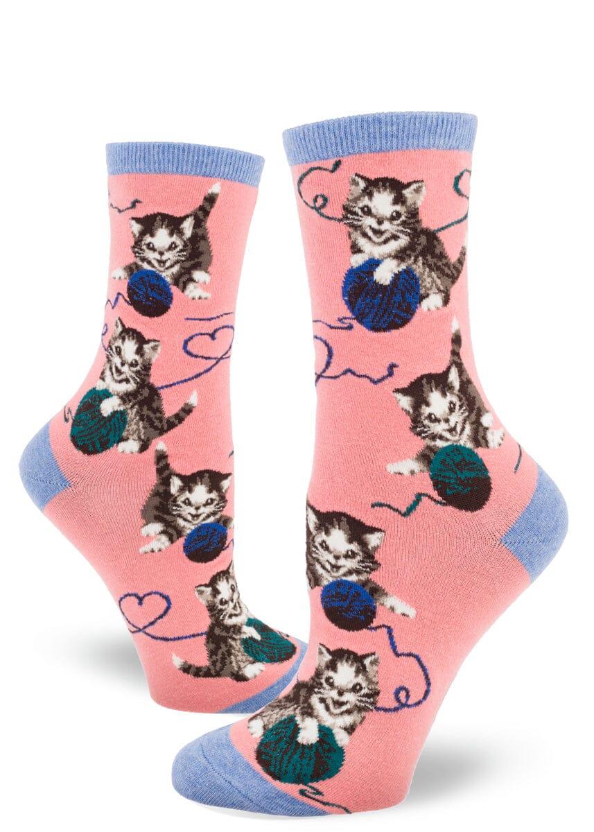 Women's string cat crew socks in pink with vintage kittens and yarn balls, flat lay