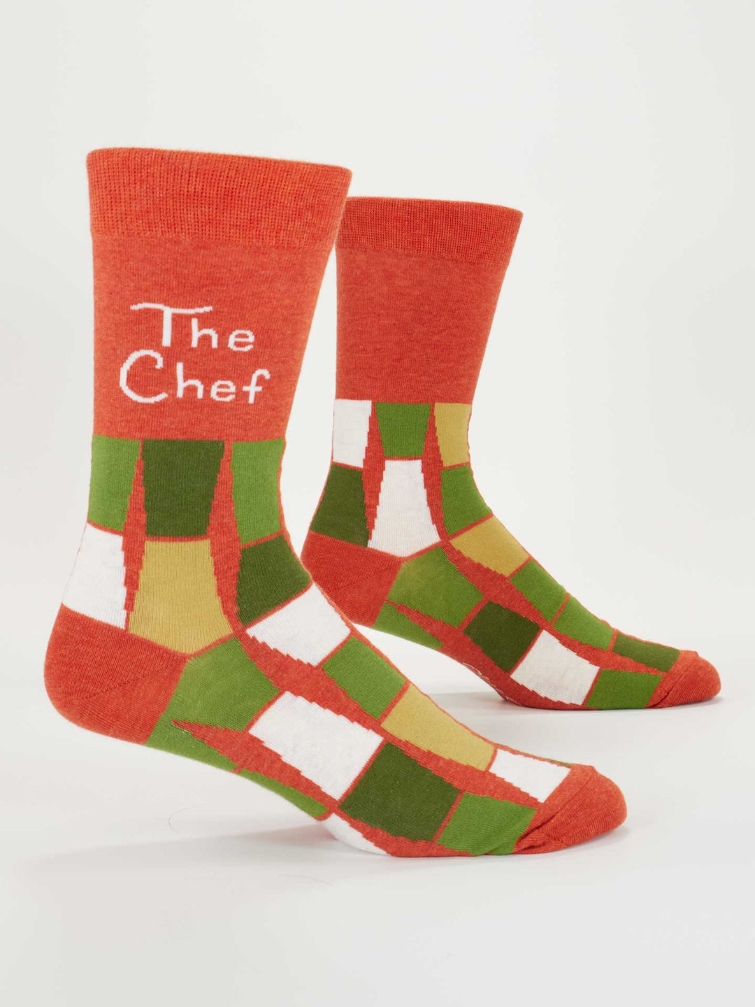 Blue Q The Chef M-Crew Socks feature a red, green, white, and gold pattern with “The Chef” in white on the upper part of one sock. Made of combed cotton, they fit men's shoe size 7-12.
