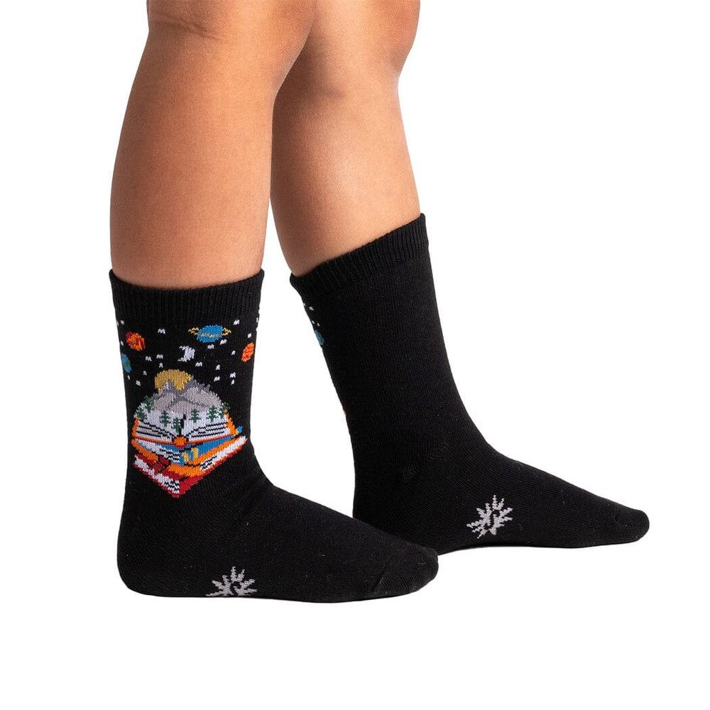 Kids' storybook galaxy crew socks worn, side view on child's legs