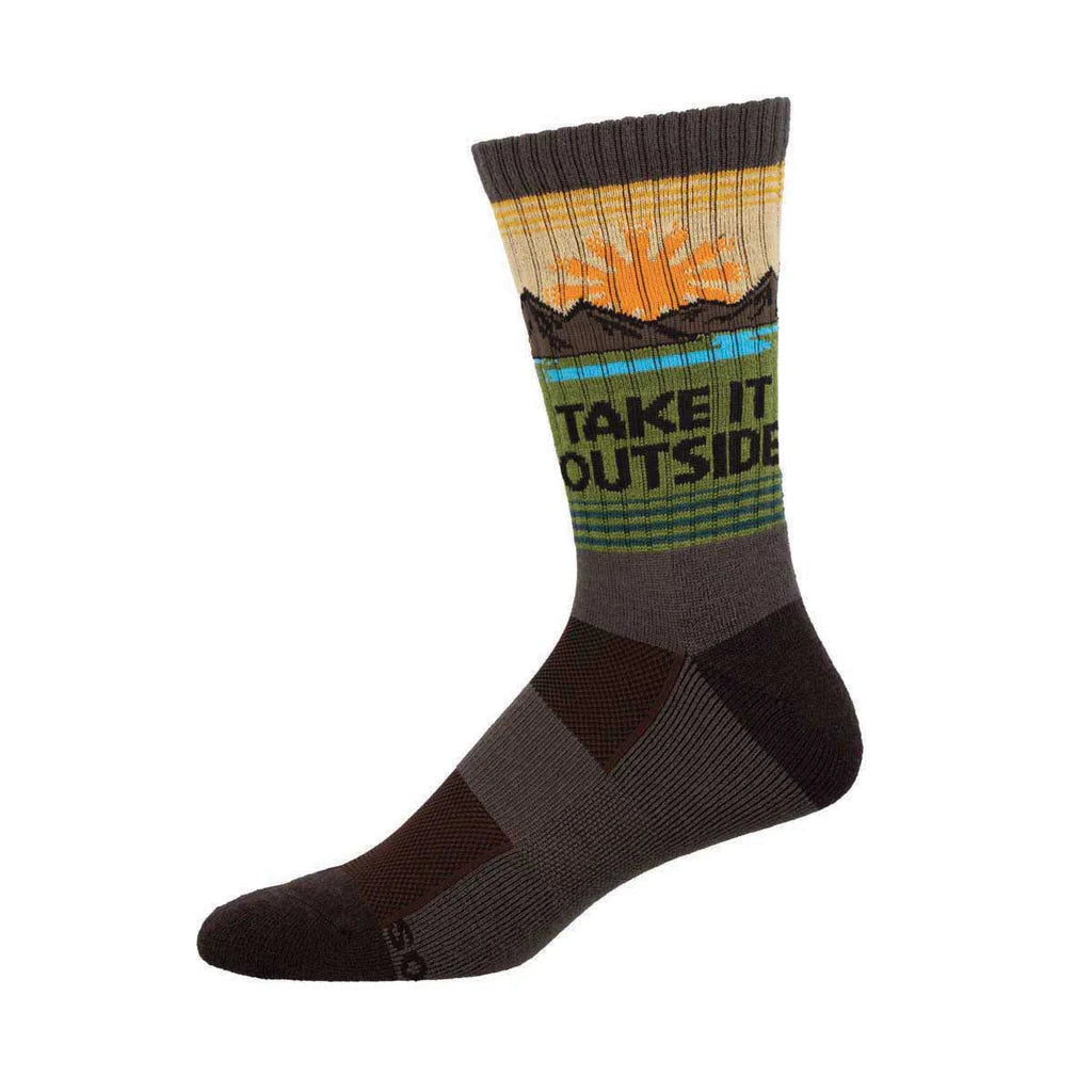 Men's mountain crew socks in brown with sunrise and Take It Outside text, worn on foot