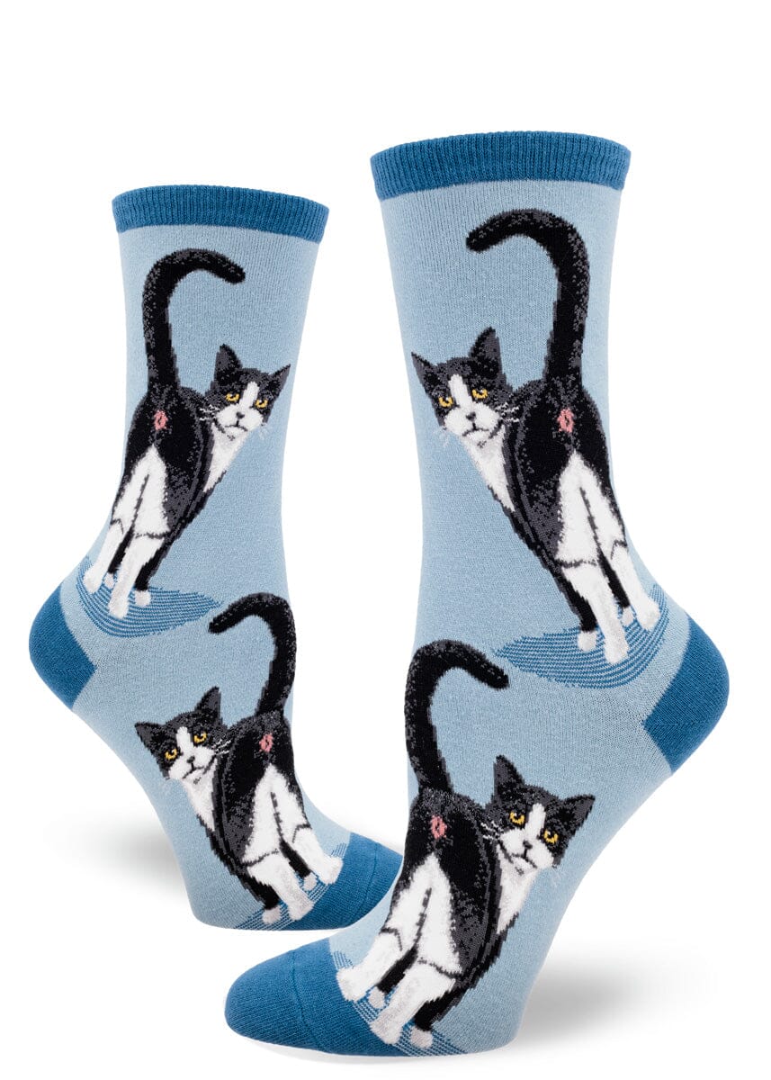 Women's tuxedo cat butt crew socks shown flat on slate blue with cats from behind