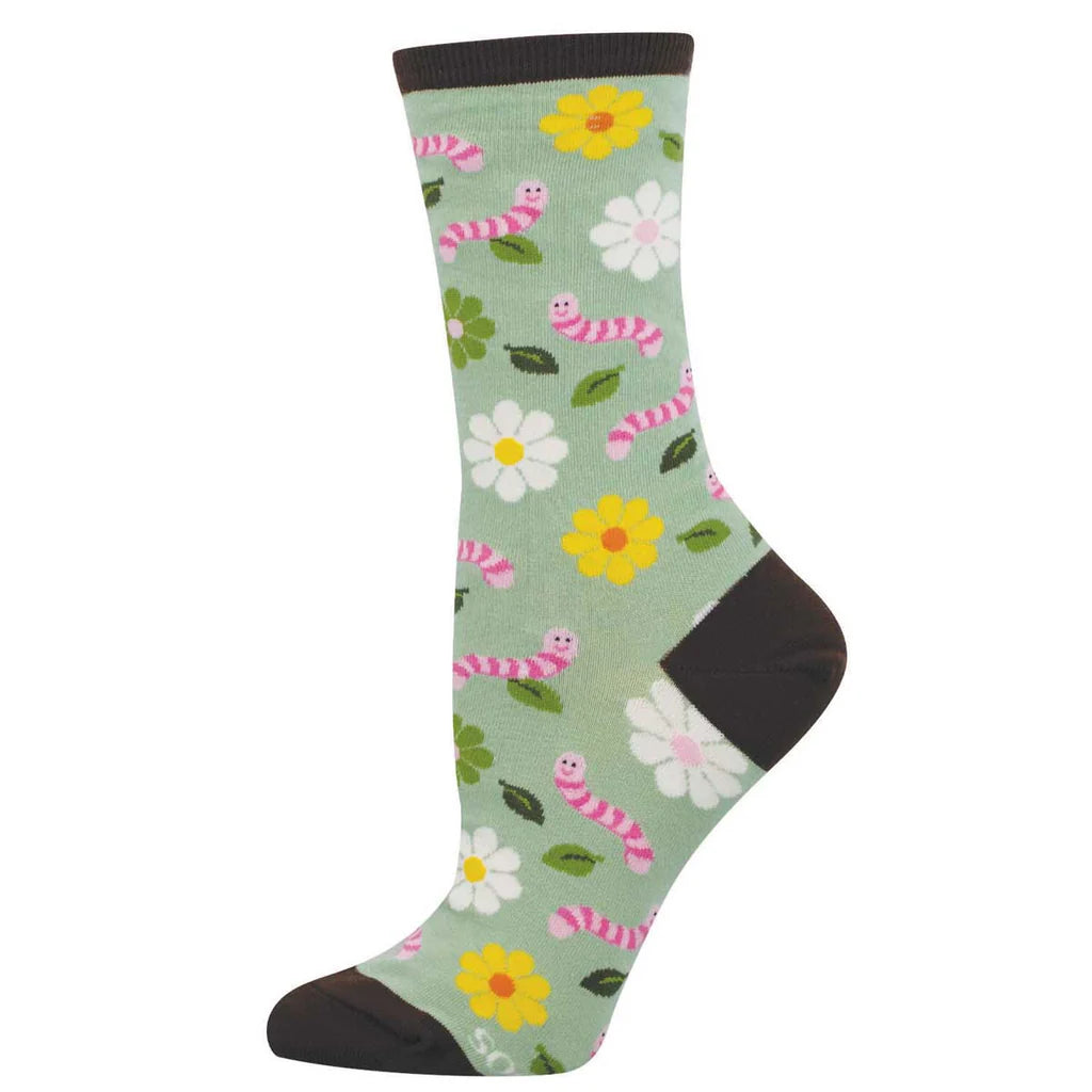 Women's worm crew socks laid flat, sage green with smiling pink worms, yellow and white daisies, and leaves
