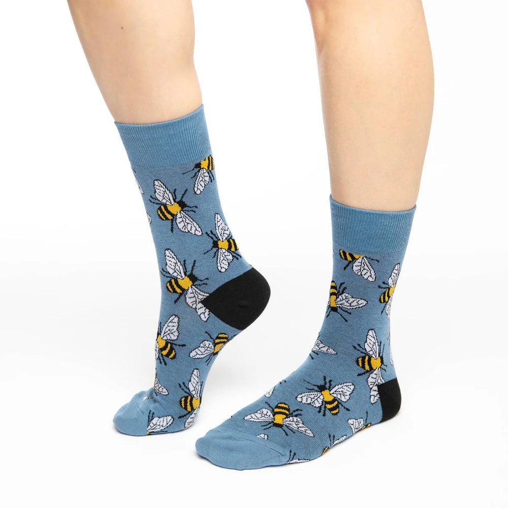 Women's slate-blue bumblebee crew socks, angled worn view