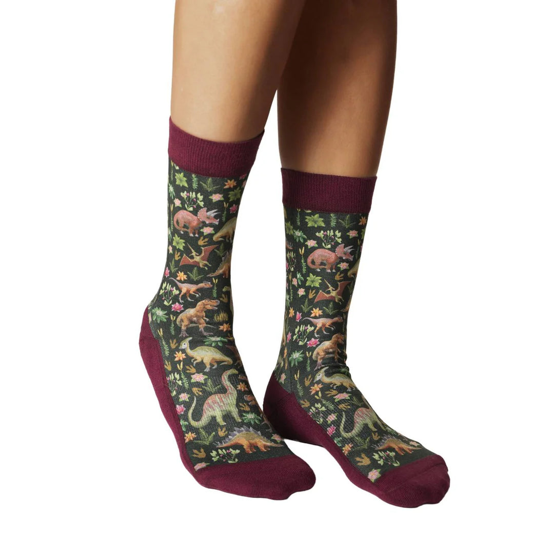 Women's floral dinosaur crew socks laid flat with dinosaurs and flowers