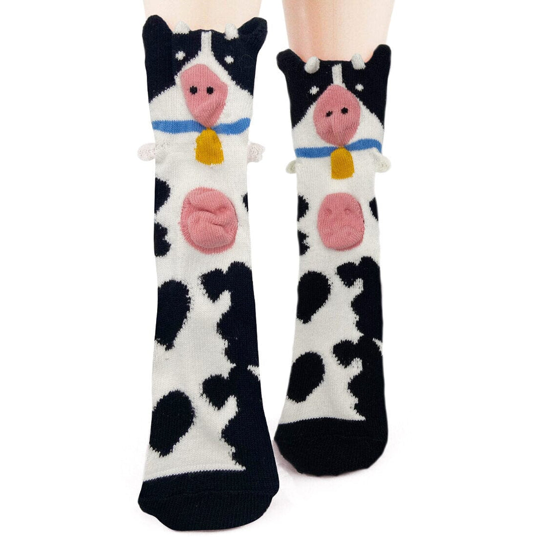 Women's 3D cow crew socks in black-and-white spots with pop-out cow faces, knit horns, blue collars and yellow bells