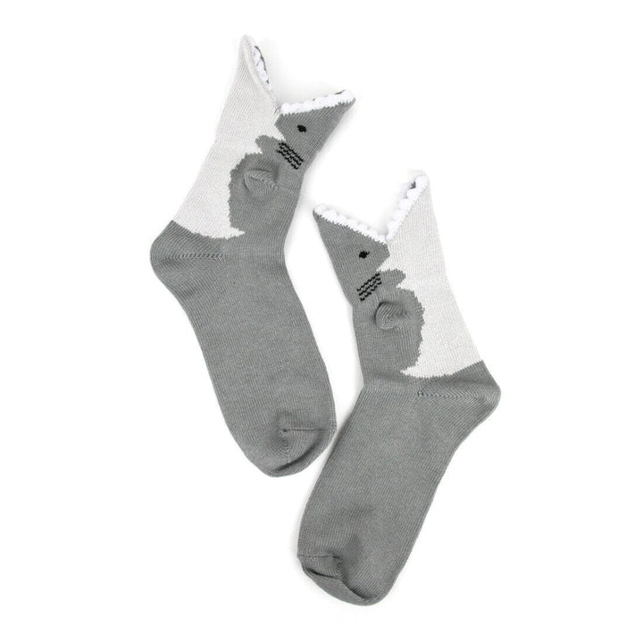 Flat-lay pair of grey 3D shark crew socks displaying the shark face and fin detail