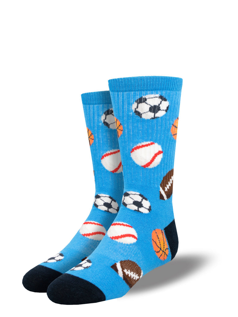Pair of kids' bright blue athletic crew socks with soccer balls, baseballs, footballs, and basketballs and navy heels and toes