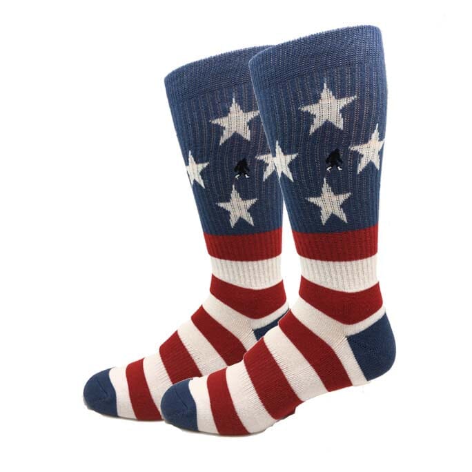 Men's USA flag crew socks, flat front view with white stars, red-and-white stripes and a small hidden Bigfoot