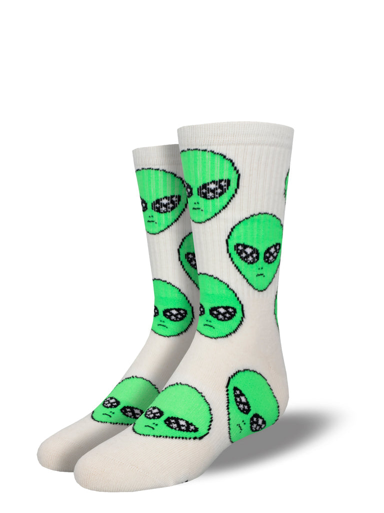 Pair of kids' cream ribbed athletic crew socks covered in green alien faces with sparkly silver eyes