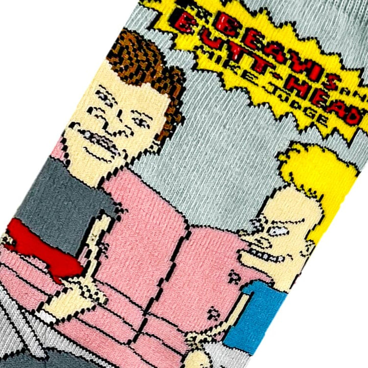 Close-up knit detail of Beavis and Butt-Head slouched on the pink couch with the MTV logo