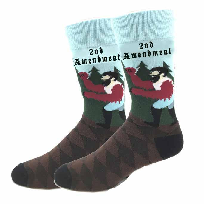 Pair of unisex crew socks showing a muscular Bigfoot flexing with 2nd Amendment text and a brown argyle foot