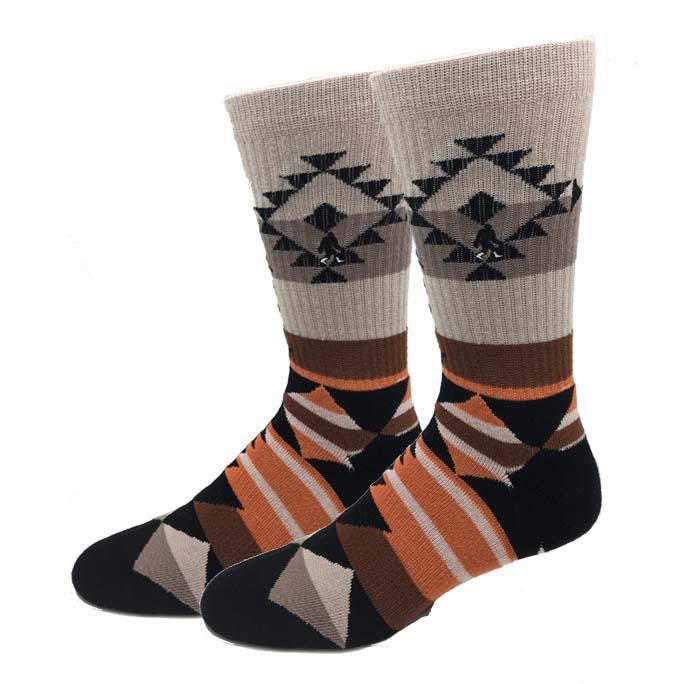 Pair of men's active crew socks with a cream Aztec-diamond cuff and rust, brown, and tan southwestern stripes