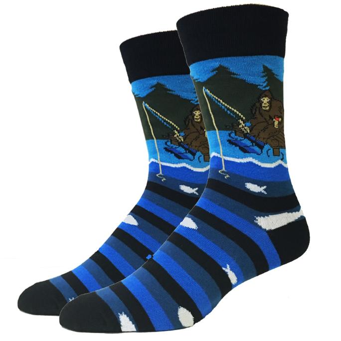 Pair of unisex crew socks showing Bigfoot fishing from a boat with blue striped water and white fish