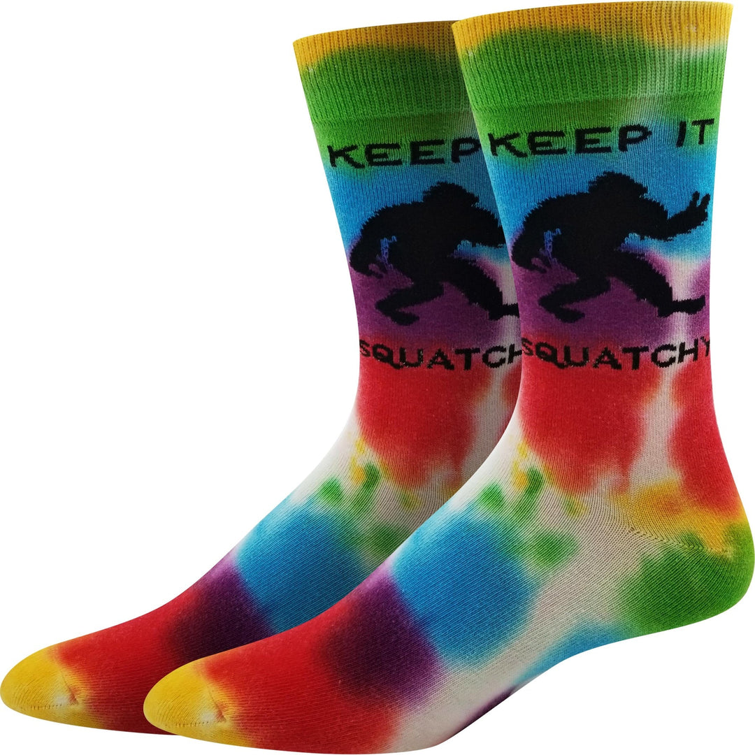 Pair of rainbow tie-dye unisex crew socks with a black Bigfoot silhouette and Keep It Squatchy text