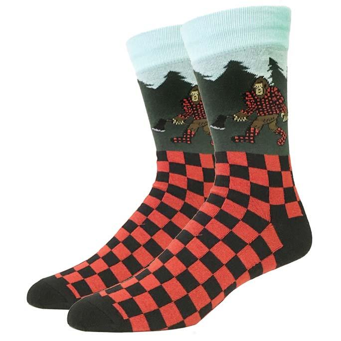 Pair of unisex crew socks showing a Bigfoot in red plaid lumberjack gear with a red and black buffalo check foot