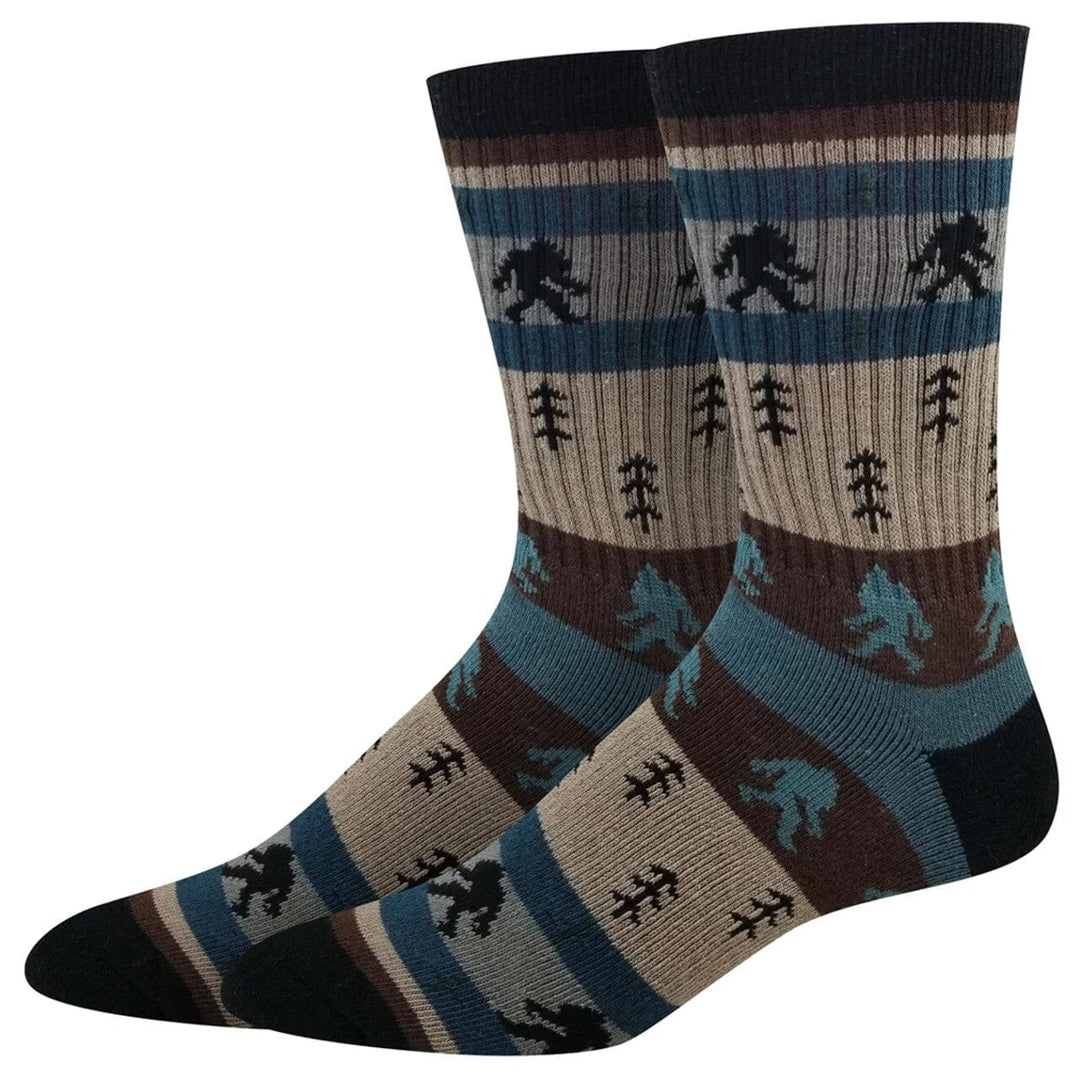 Men's Bigfoot striped active crew socks shown as a pair with Sasquatch silhouettes and pine trees on earthy stripes