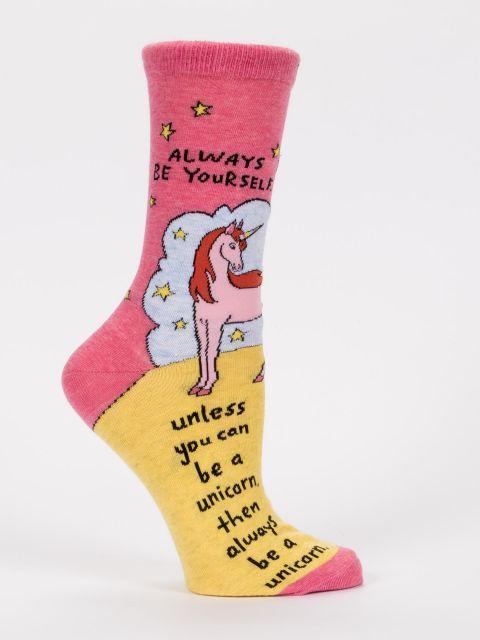 Side view of a women's pink and yellow crew sock featuring a pastel unicorn on clouds with the "always be a unicorn" quote and scattered stars