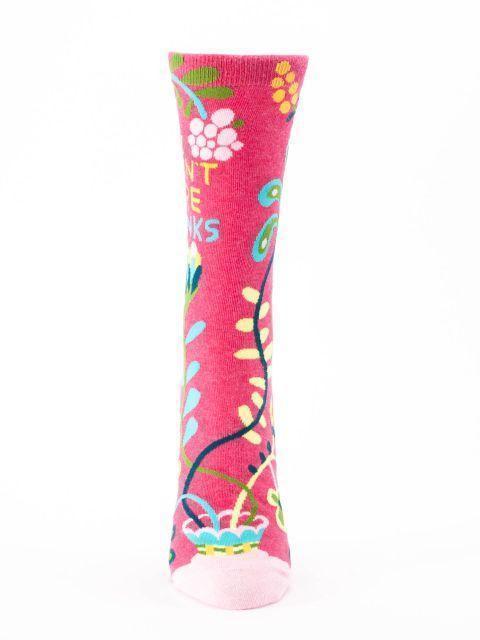 Front view of the Hi I Don't Care crew sock showing the slogan partly visible and colorful folk flowers up the leg