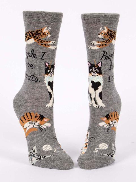 Women's gray cat crew socks shown from the front featuring a tabby, tuxedo cat and calico across the feet