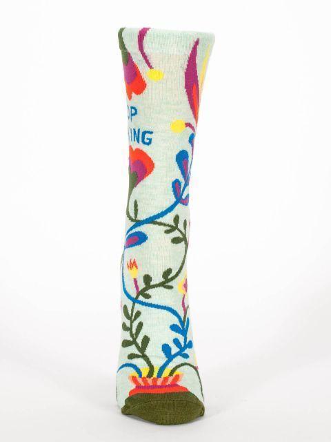 Front view of the "Stop Talking" sock showing trailing vines and blooms down the foot