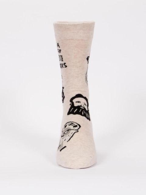 Front-facing view of the oatmeal beard socks standing upright, showing bearded characters scattered across the leg and foot