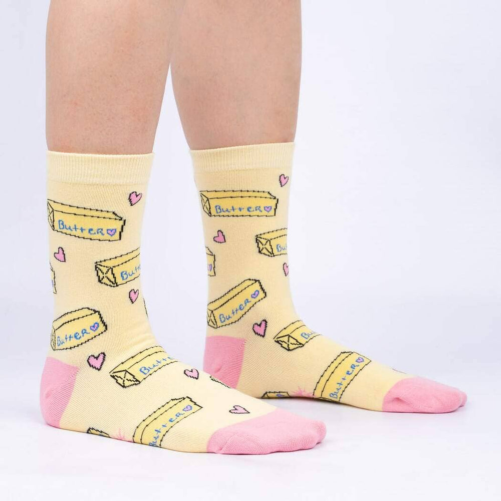 Side view of the butter crew socks worn on legs, showing the butter pattern and pink heel