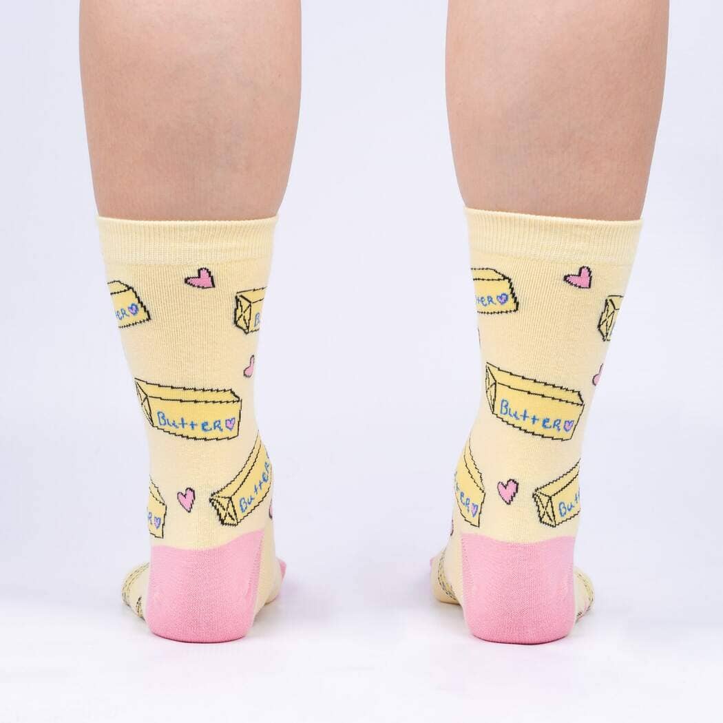 Back view of the butter crew socks on legs, showing butter sticks and hearts on yellow