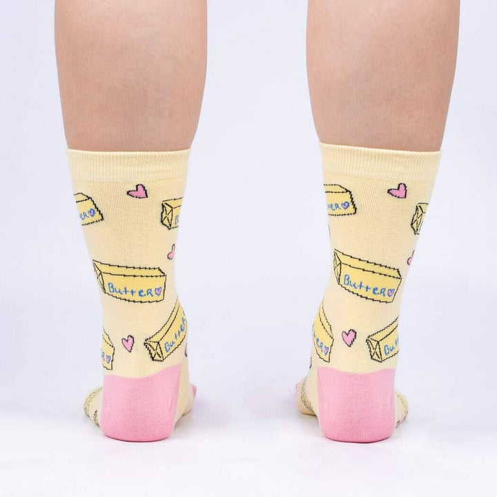 Back view of the butter crew socks on legs, showing butter sticks and hearts on yellow