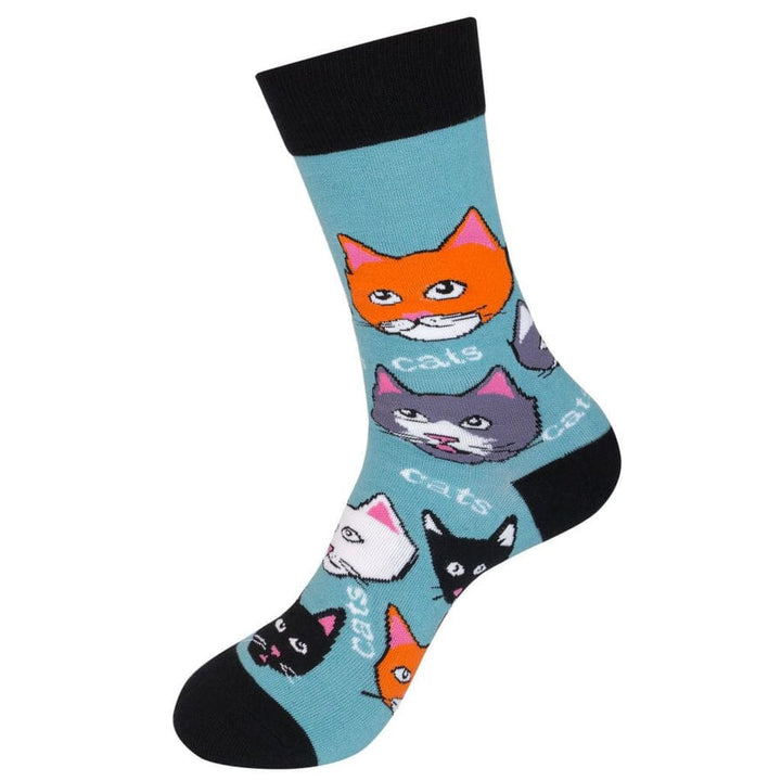 Standing side view of the teal cat sock showing orange, gray and black kitty faces