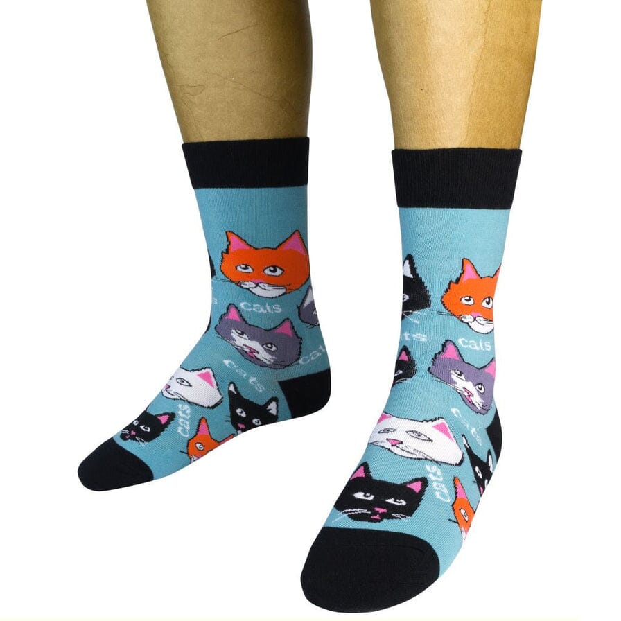 Two teal cat-face socks worn on a model showing the colorful kitty pattern