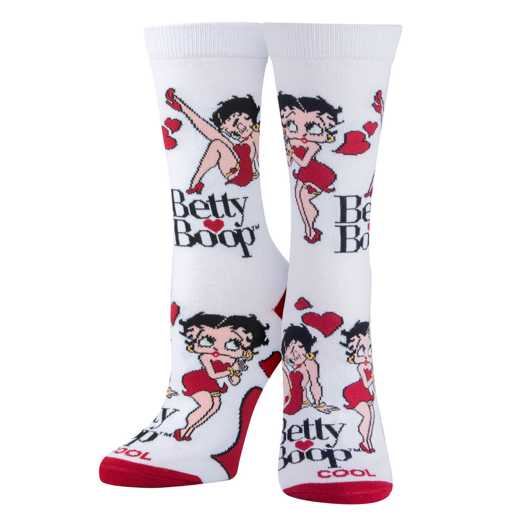 White women's crew socks with Betty Boop in a red dress posing among red hearts and her logo, with red heels and toes