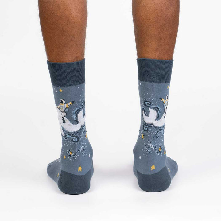 Back view of the cosmic whale crew socks worn, showing astronaut and whale on the back