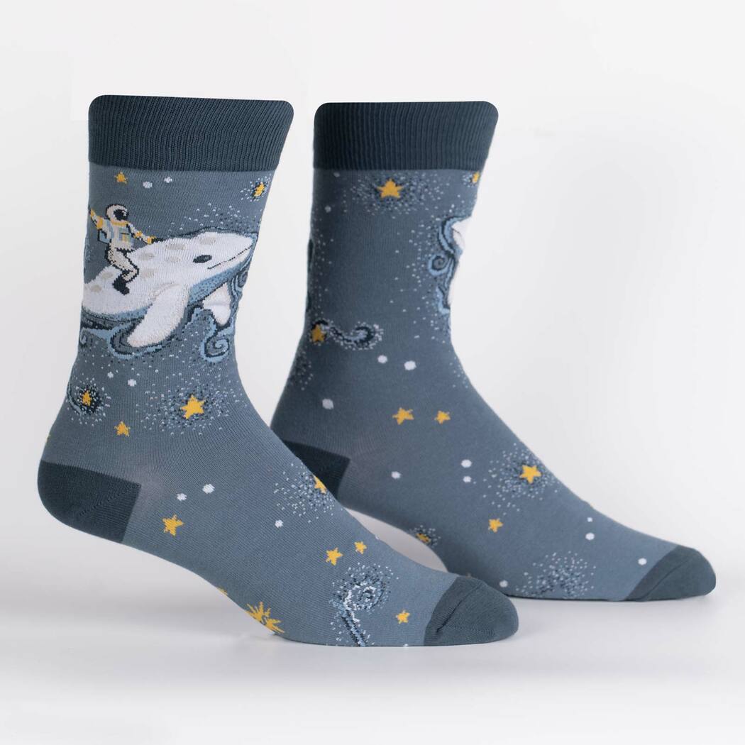Pair of cosmic whale crew socks on display, showing astronaut and beluga design