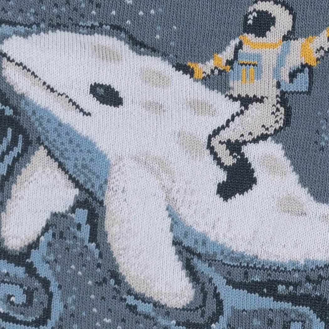 Close-up of the astronaut surfing on the beluga whale design